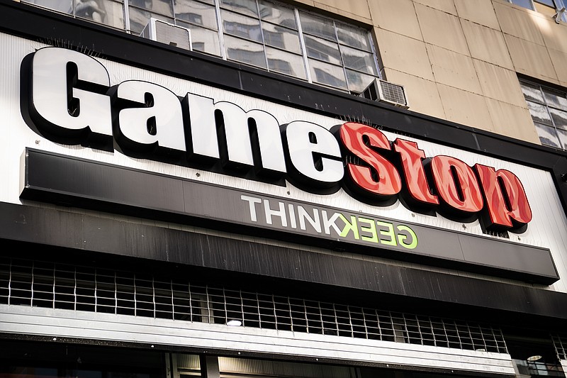 FILE - Pedestrians pass a GameStop store on 14th Street at Union Square, Thursday, Jan. 28, 2021, in the Manhattan borough of New York. Behind GameStop's stock surge is the grim reality that the video game retailer is floundering even as the industry around it is booming. Many investors fully understand the contradiction between GameStop's stock price and its business fundamentals. But for those who imagine it to be the next Tesla or Amazon, the truth is: It's likely not. (AP Photo/John Minchillo, File)