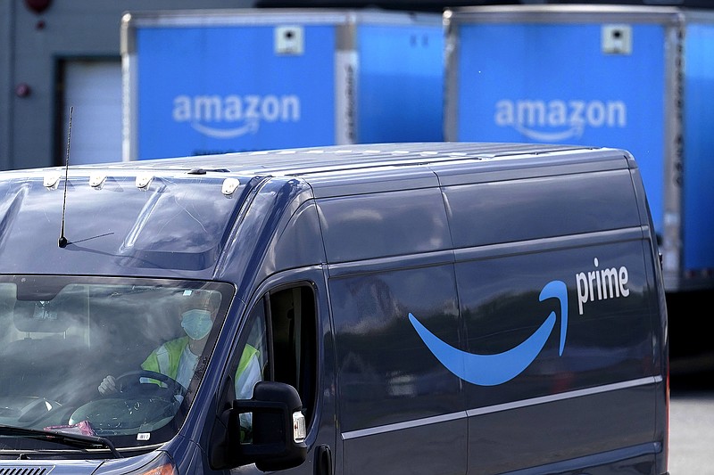 FILE - In this Oct. 1, 2020, file photo, an Amazon Prime logo appears on the side of a delivery van as it departs an Amazon Warehouse location in Dedham, Mass. Amazon announced Tuesday, Feb. 2, 2021, that Jeff Bezos would step down as CEO later in the year, leaving a role he's had since founding the company nearly 30 years ago. (AP Photo/Steven Senne, File)