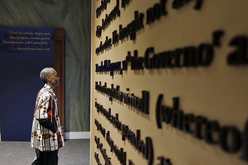 In this Aug. 24, 2019 file photo, Jerome Jones explores inside the Fort Monroe Visitor And Education Center during the First African Landing Commemorative Ceremony at Fort Monroe, Va. Officials observed the arrival of enslaved Africans 400 years earlier to what is now Virginia. Proposals in Arkansas, Iowa and Mississippi would prohibit schools from using a New York Times project that focused on slavery's legacy. (Jonathon Gruenke/The Daily Press via AP)