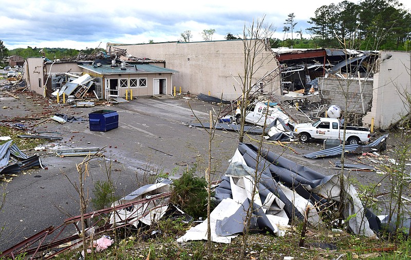 Staff Photo by Robin Rudd / The back part of Bones Smokehouse, left, is all that remains of the eatery.  At right is the walls of the Goodwill store show extensive damage.  The Chattanooga Area was hit by EF 3 tornado on the night of April 12, 2020.