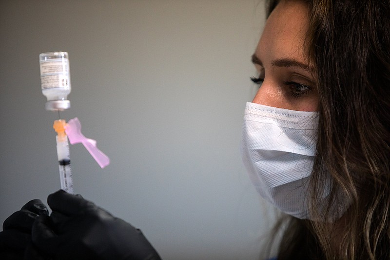 Staff photo by Troy Stolt / RN Lauren Dean fills syringes with the Moderna COVID-19 vaccine inside of the pharmacy at the Hamilton County Health Department's new COVID Vaccination POD at the CARTA Bus Terminal on Thursday, Jan. 28, 2021, in Chattanooga, Tenn.