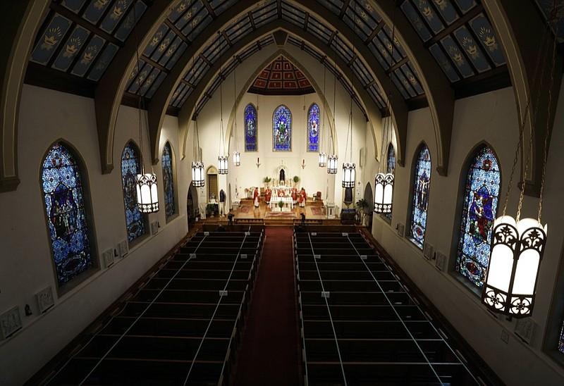 FILE - In this Sunday, April 5, 2020, file photo, The Most Rev. Peter Jugis, Bishop of Charlotte, conducts Palm Sunday services inside the empty St. Patrick Cathedral in Charlotte, N.C. (David T. Foster III/The Charlotte Observer via AP)


