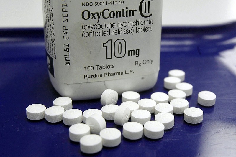 FILE - This Feb. 19, 2013, file photo shows OxyContin pills arranged for a photo at a pharmacy in Montpelier, Vt. The global business consulting firm McKinsey & Company has agreed to a $573 million settlement over its role in the opioid crisis, according to a person with knowledge of the deal. An announcement is expected Thursday, Feb. 4, 2021. (AP Photo/Toby Talbot, File)