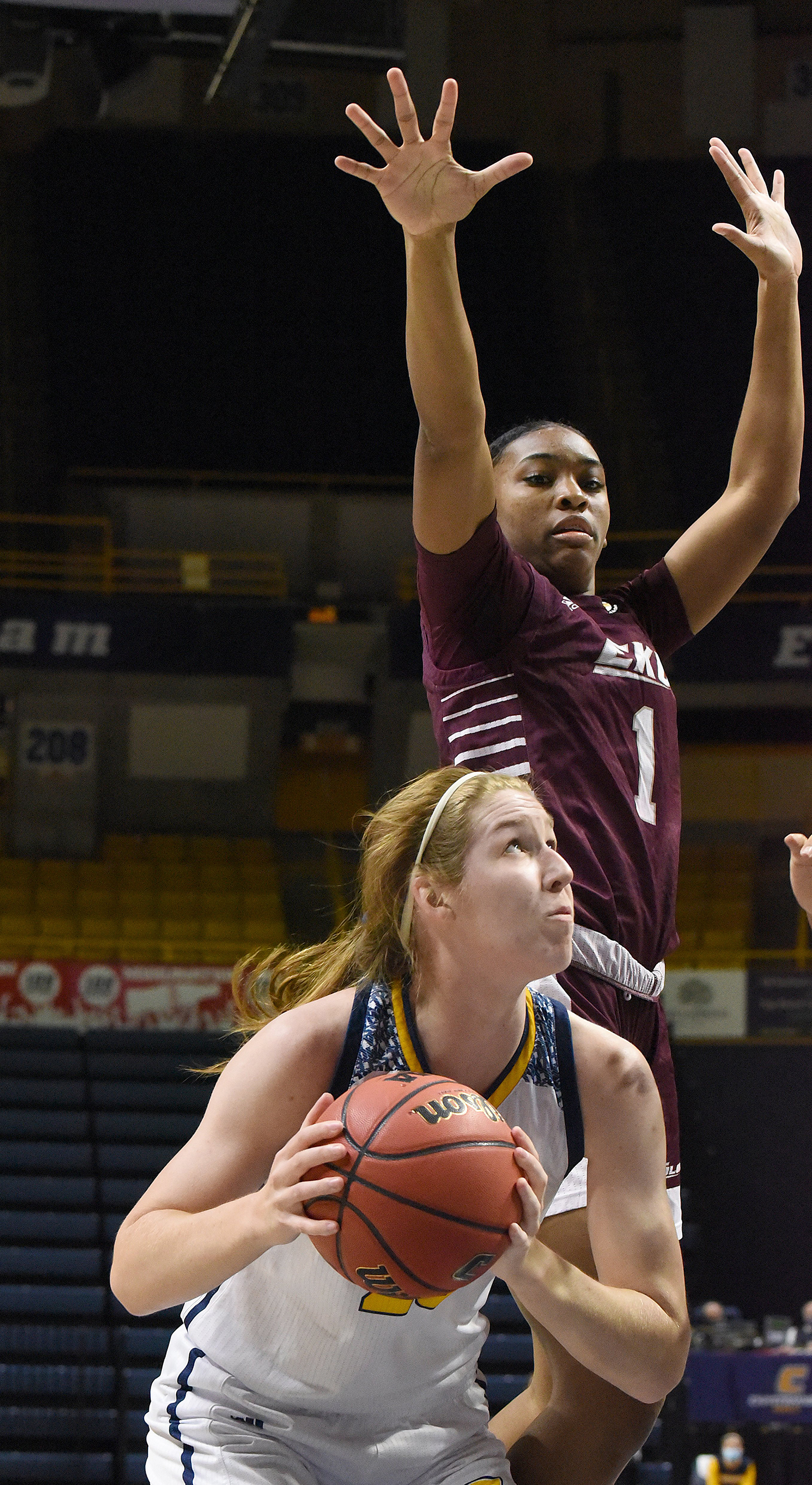 Staff photo by Matt Hamilton / UTC's Abbey Cornelius prepares to shoot as Eastern Kentucky's Corriana Evans leaps in defense on Dec. 18 at McKenzie Arena.