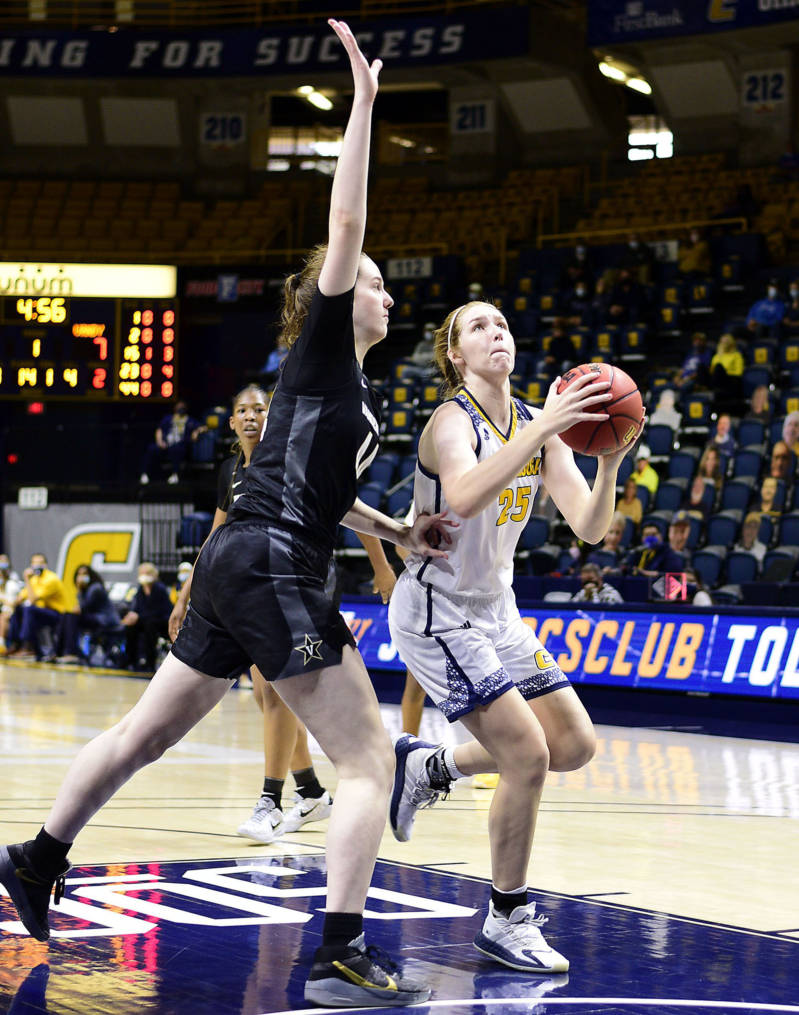 Staff photo by Robin Rudd / UTC's Abbey Cornelius drives to the basket past Vanderbilt's Emily Bowman on Dec. 13 at McKenzie Arena.
