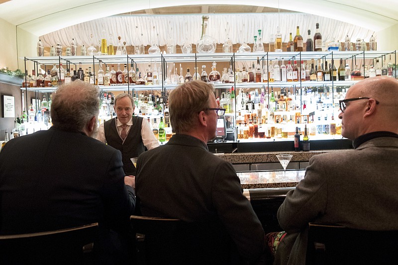 In this Tuesday, Nov. 27, 2018, photo, a bartender talks to a customer at the Gotham Bar and Grill in New York. The Manhattan upscale restaurant hopes to reopen by summer 2021 if government regulations permit, but will likely have just 35 staffers instead of the 100 the restaurant had before it closed in March 2020. (AP Photo/Mary Altaffer)