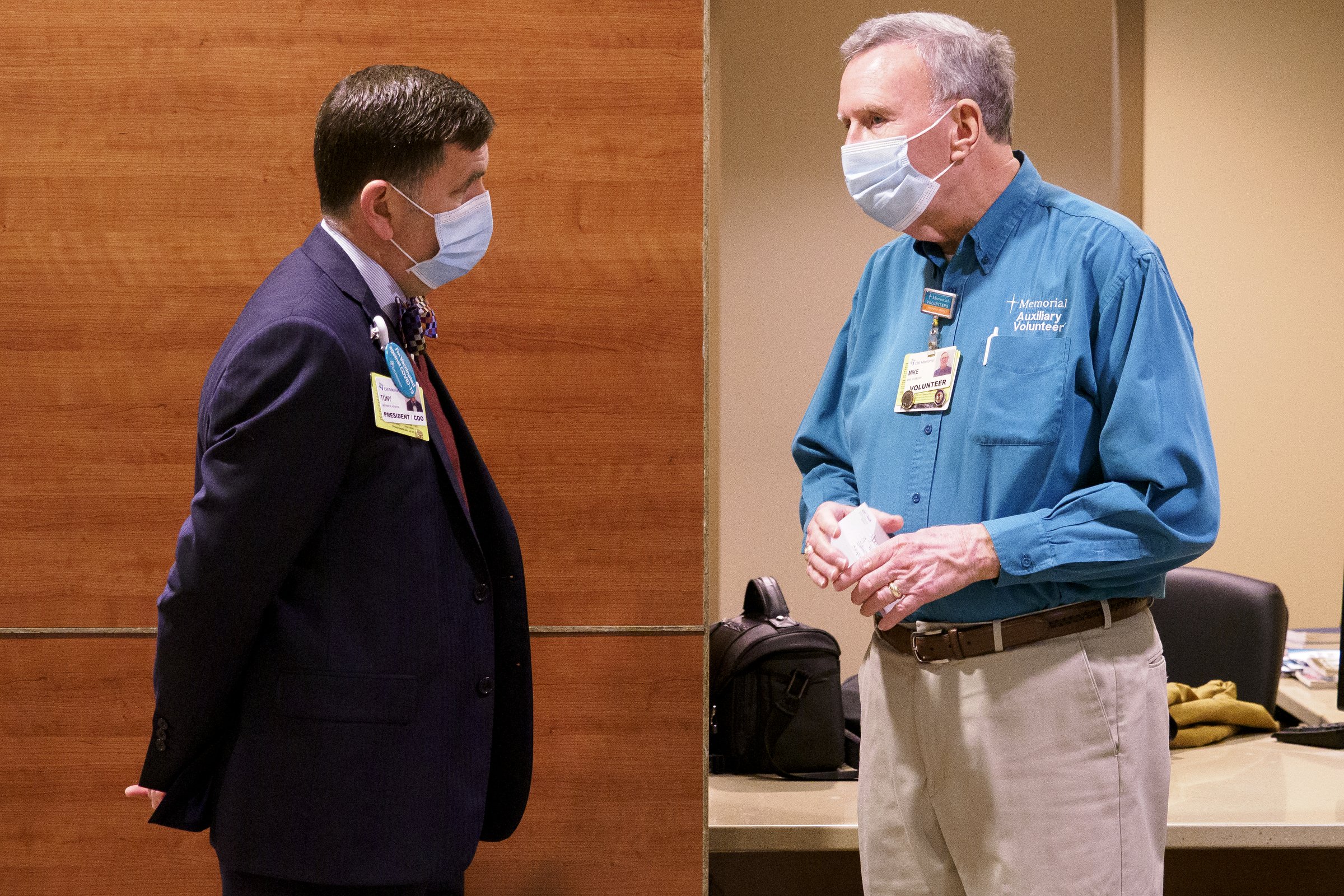 Staff photo by C.B. Schmelter / President and COO Anthony Houston, left, talks with volunteer Mike Doubleday at CHI Memorial Hospital on Monday, Feb. 1, 2021 in Chattanooga, Tenn. The hospital welcomed back volunteers who have been fully vaccinated.
