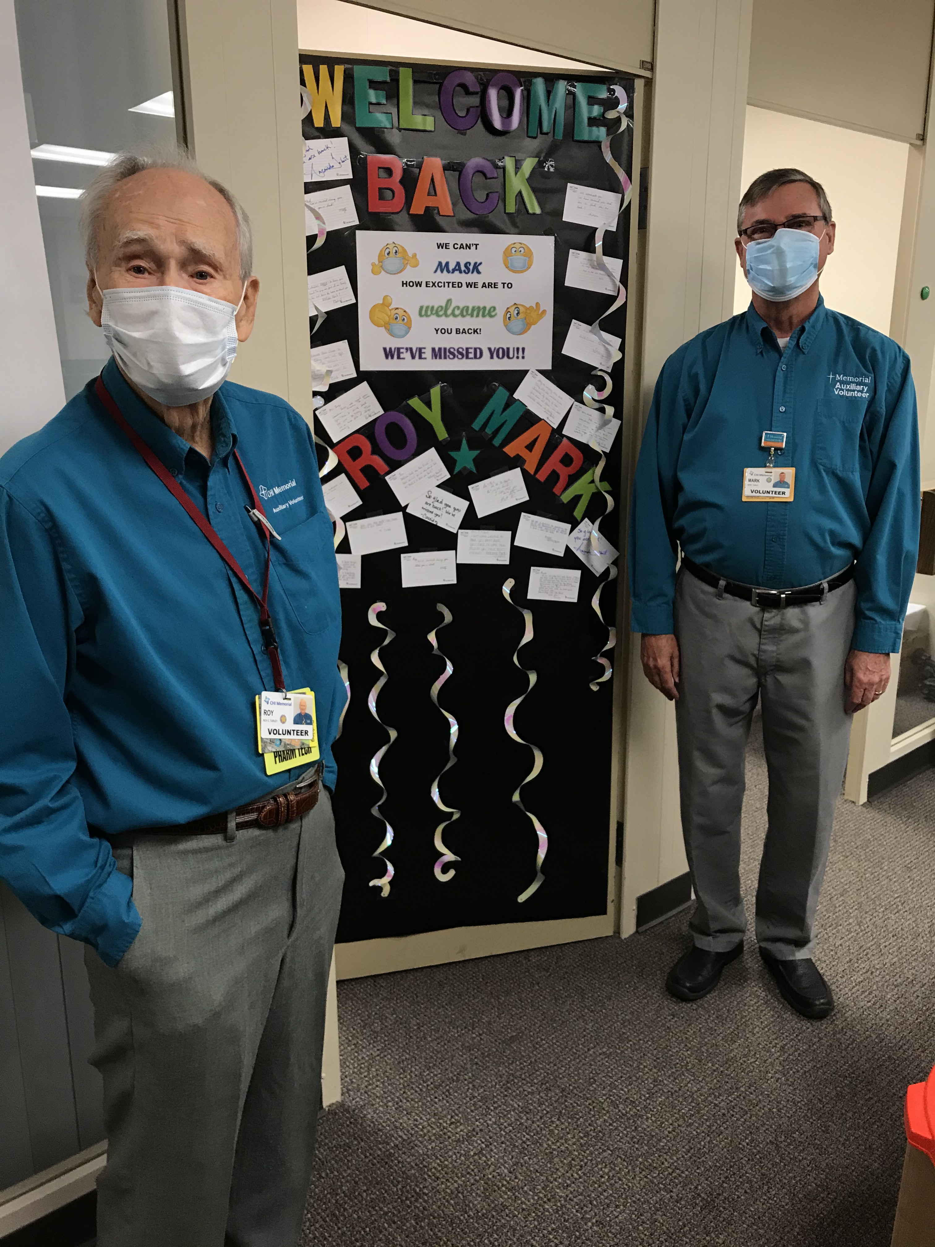 Photo contributed by Karen Long / Volunteers Ron Turley, left, and Mark Turley are pictured beside their welcome-back sign at CHI Memorial Hospital.