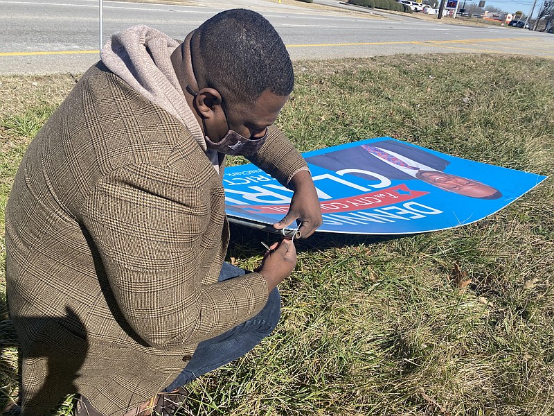 City Council Candidate Dennis Clark replants a campaign sign on Highway 58 in Chattanooga on Tuesday, Feb. 2, 2021, after he alleged it was displaced the night before. Clark is one of four candidates for the open District 5 Chattanooga City Council seat. / Staff Photo by Sarah Grace Taylor