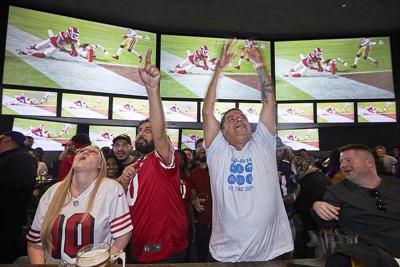 AP photo by Damian Dovarganes / Fans react at Tom's Watch Bar LA Live in Los Angeles as the Kansas City Chiefs' Damien Williams scores a touchdown against the San Francisco 49ers during Super Bowl LIV on Feb. 2, 2020.
