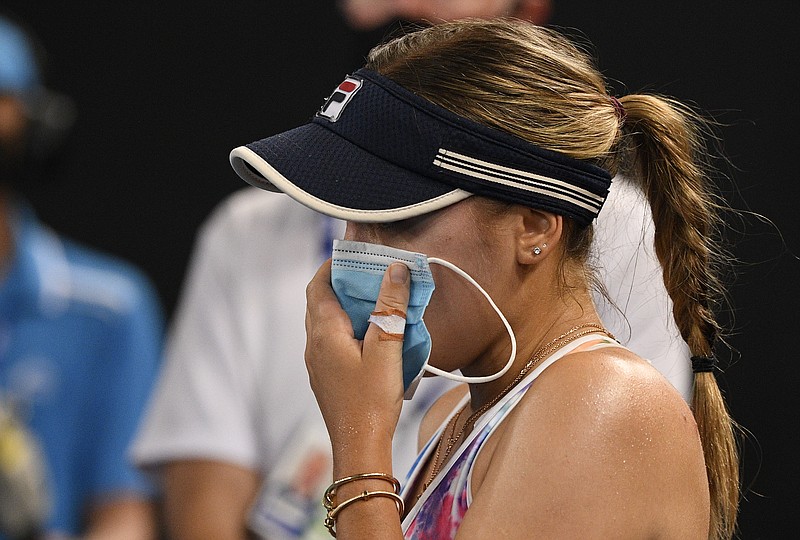 AP photo by Andy Brownbill / Sofia Kenin holds a mask to her face during a match against Garbine Muguruza in an Australian Open tuneup tournament Friday in Melbourne. The year's first Grand Slam tennis tournament is set to start Monday in Australia.