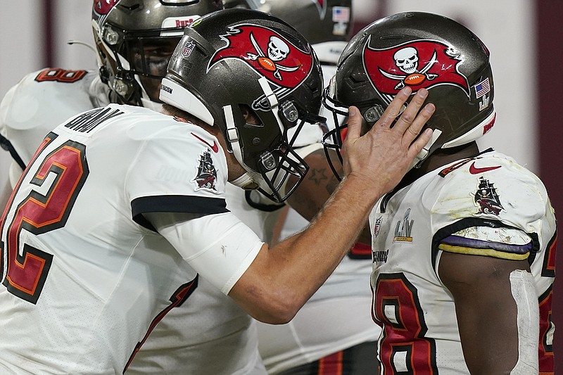 AP photo by Lynne Sladky / Tampa Bay Buccaneers running back Leonard Fournette, right, celebrates with quarterback Tom Brady after scoring on a 27-yard touchdown run against the Kansas City Chiefs during the second half of Super Bowl LV on Sunday night in Tampa, Fla.