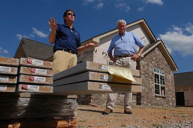 Win Pratt, left, and his father, James Pratt, talk in front of their Stonebrook Neighborhood development in Ooltewah in 2010. / Staff file photo