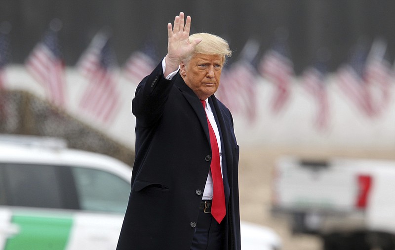 The Associated Press / Then-President Donald Trump waves to the crowd while at the border wall in Alamo, Texas, last month.