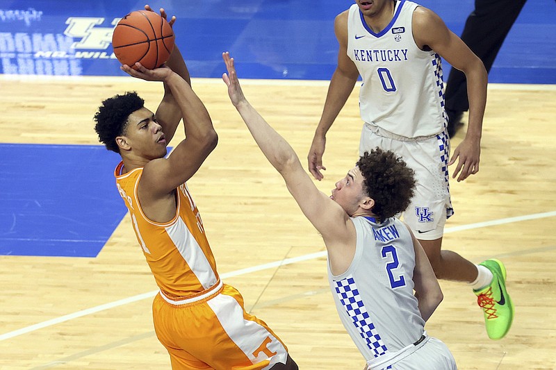 Tennessee's Jaden Springer, left, shoots while defended by Kentucky's Devin Askew during the first half of an NCAA college basketball game in Lexington, Ky., Saturday, Feb. 6, 2021. (AP Photo/James Crisp)