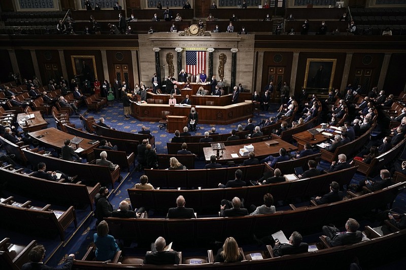 FILE - In this Jan. 6, 2021, file photo the Republican side, right, in the House chamber is seen as Speaker of the House Nancy Pelosi, D-Calif., and Vice President Mike Pence officiate as a joint session of the House and Senate convenes to count the Electoral College votes cast in November's election, at the Capitol in Washington. Arguments begin Tuesday, Feb. 9, in the impeachment trial of Donald Trump on allegations that he incited the violent mob that stormed the U.S. Capitol on Jan. 6. (AP Photo/J. Scott Applewhite, Pool, File)