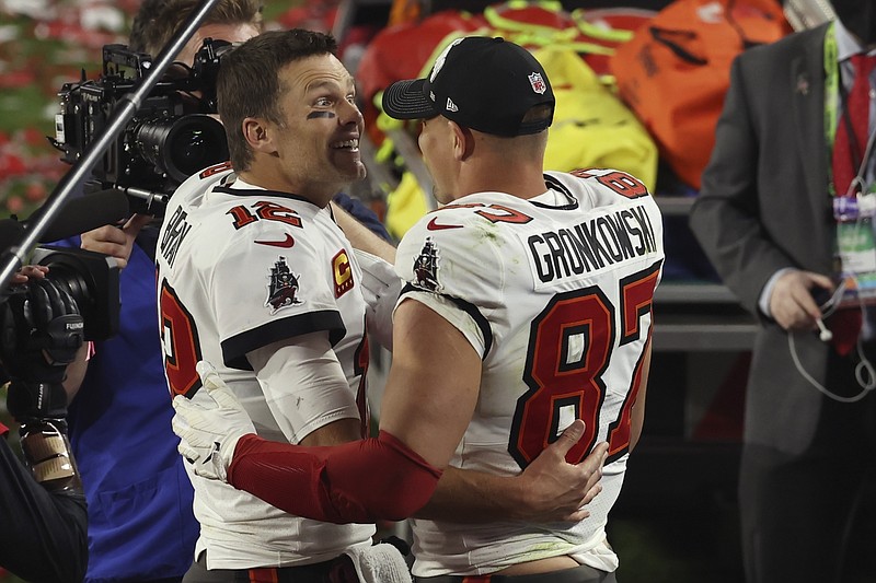 Tampa Bay Buccaneers quarterback Tom Brady (12) and Rob Gronkowski (87) celebrate their win in the NFL Super Bowl 55 football game against the Kansas City Chiefs Sunday, Feb. 7, 2021, in Tampa, Fla. The Buccaneers defeated the Chiefs 31-9 to win the Super Bowl. (AP Photo/Mark LoMoglio)