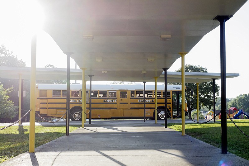 Staff photo by C.B. Schmelter / A school bus waits to drop off students at the front entrance on the first day of school at Hixson Elementary School on Wednesday, Aug. 12, 2020 in Hixson, Tenn. Hamilton County Schools will enter phase 3 of its reopening plan next week, bringing most students back to the classroom.