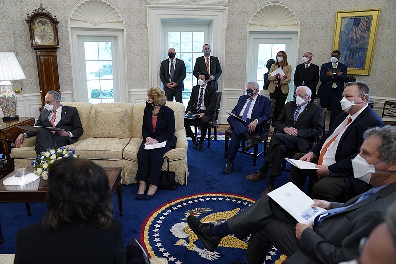 Photo by Evan Vucci of The Associated Press / In this Feb. 3, 2021, file photo, President Joe Biden and Vice President Kamala Harris meet with Senate Majority Leader Sen. Chuck Schumer of New York, left, and other Democratic lawmakers to discuss a coronavirus relief package, in the Oval Office of the White House in Washington.