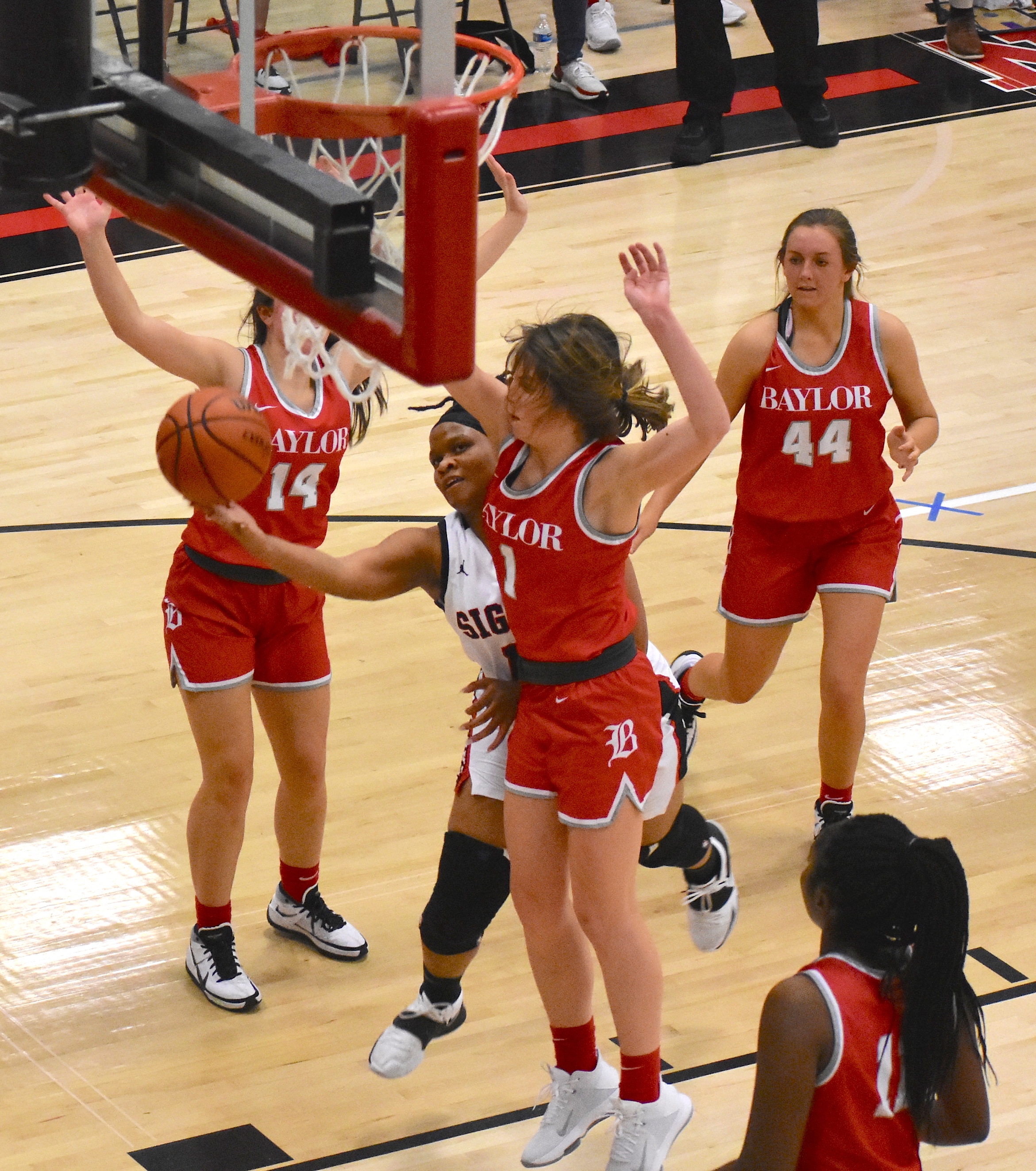 Staff photo by Patrick MacCoon / Signal Mountain's Jaylah Hardy goes around defenders to draw a foul in Monday's home victory over Baylor.