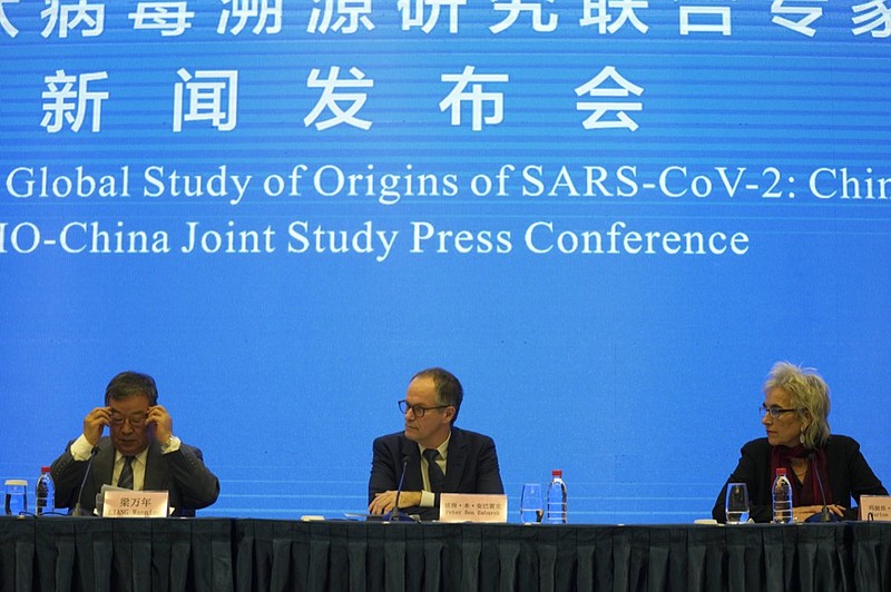 Marion Koopmans, right, and Peter Ben Embarek, center, of a World Health Organization team look over at their Chinese counterpart Liang Wannian, left, during a WHO-China Joint Study Press Conference held at the end of their mission to investigate the origins of the coronavirus pandemic in Wuhan in central China's Hubei province, Tuesday, Feb. 9, 2021. (AP Photo/Ng Han Guan)


