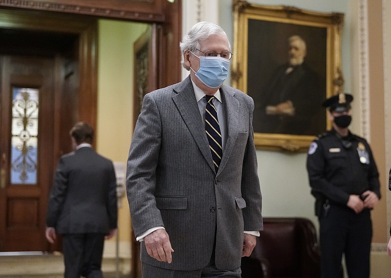 Photo by J. Scott Applewhite of The Associated Press / Senate Minority Leader Mitch McConnell, R-Kentucky, leaves the chamber during a break in the opening arguments of former President Donald Trump's impeachment trial at the Capitol in Washington on Feb. 10, 2021.