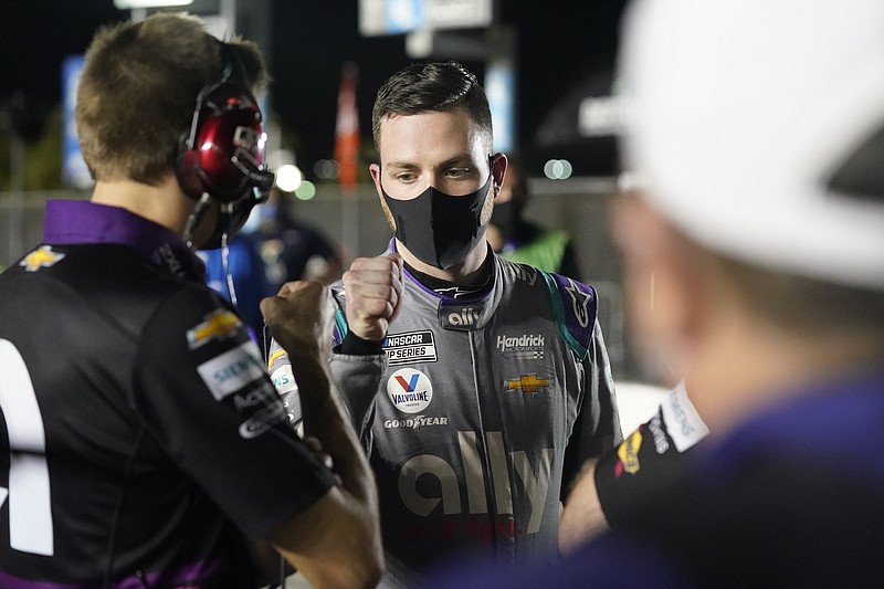 AP photo by John Raoux / Hendrick Motorsports driver Alex Bowman, right, gets a fist bump from one of the No. 48 Chevrolet's pit crew members after securing the pole position Wednesday night during a qualifying session for Sunday's Daytona 500.