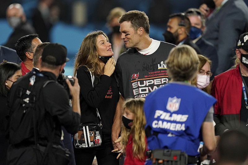 Photo by Steve Luciano of The Associated Press / Tampa Bay Buccaneers quarterback Tom Brady walks with his wife, Gisele Bundchen, on the field after the NFL Super Bowl 55 football game against the Kansas City Chiefs on Sunday, Feb. 7, 2021, in Tampa, Florida.