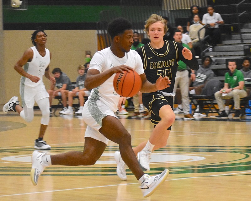 Staff photo by Patrick MacCoon / East Hamilton senior point guard Darwin Randolph, front, had 12 points, seven assists and three steals in Thursday's District 5-AAA home victory over Bradley Central.