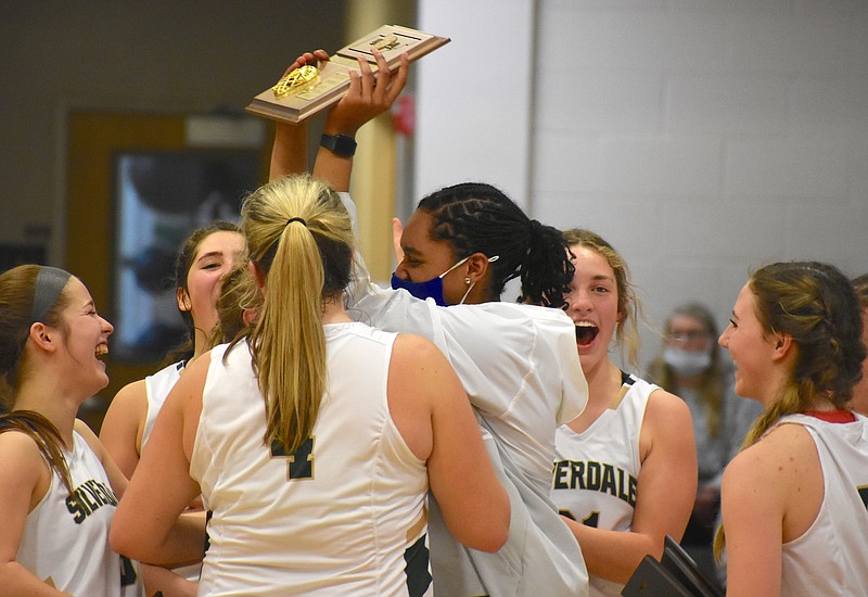 Staff photo by Patrick MacCoon / Silverdale Baptist Academy senior Laney Bone lifts the Division II-A East District 2 championship plaque as the Lady Seahawks celebrate a third straight title after their 49-36 home victory over Boyd Buchanan on Friday night.