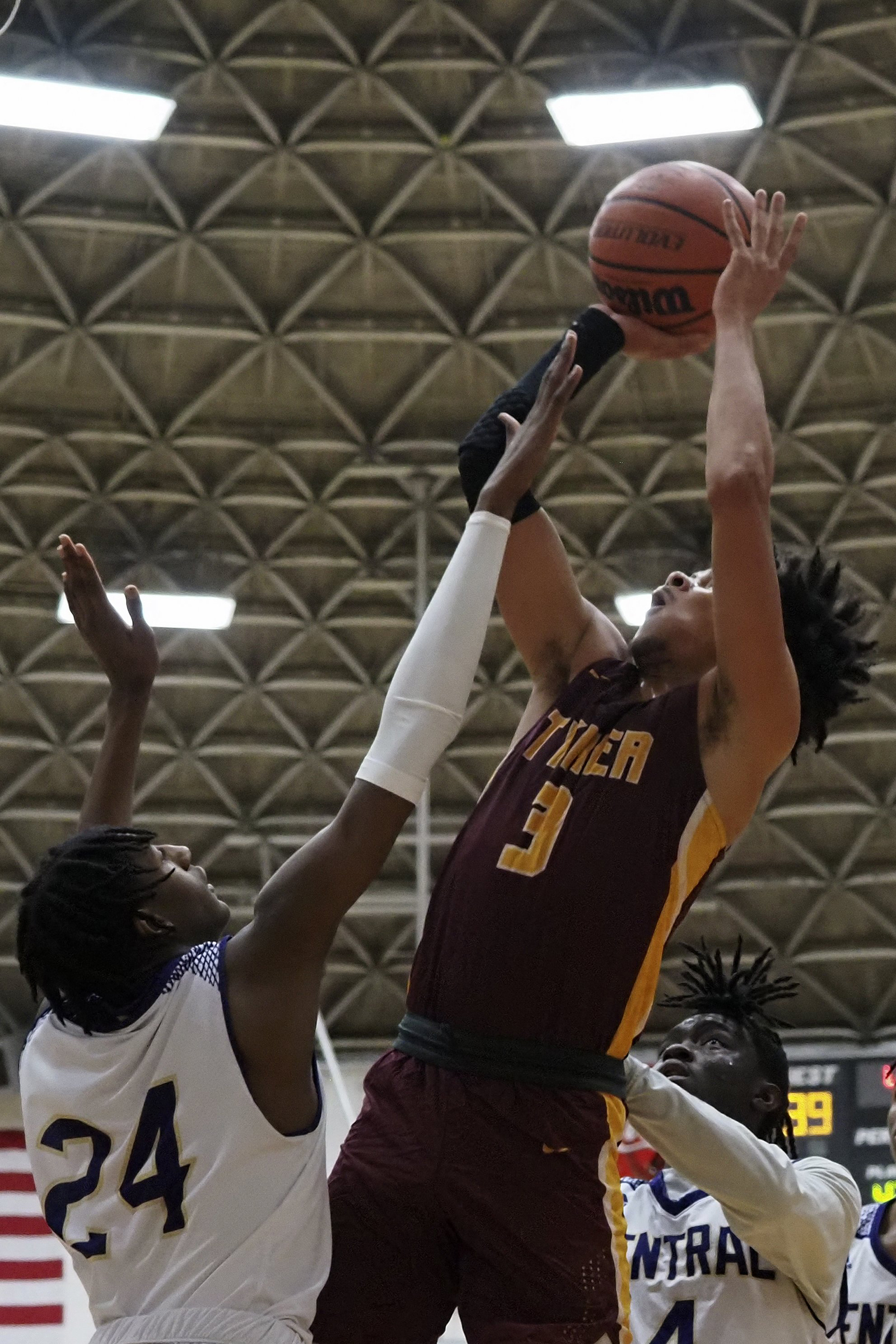 Staff photo by C.B. Schmelter / Tyner's Amarion Dillard (3) takes a shot over Central's Matthew Sharpe (24) at Central High School on Friday, Feb. 12, 2021 in Chattanooga, Tenn.