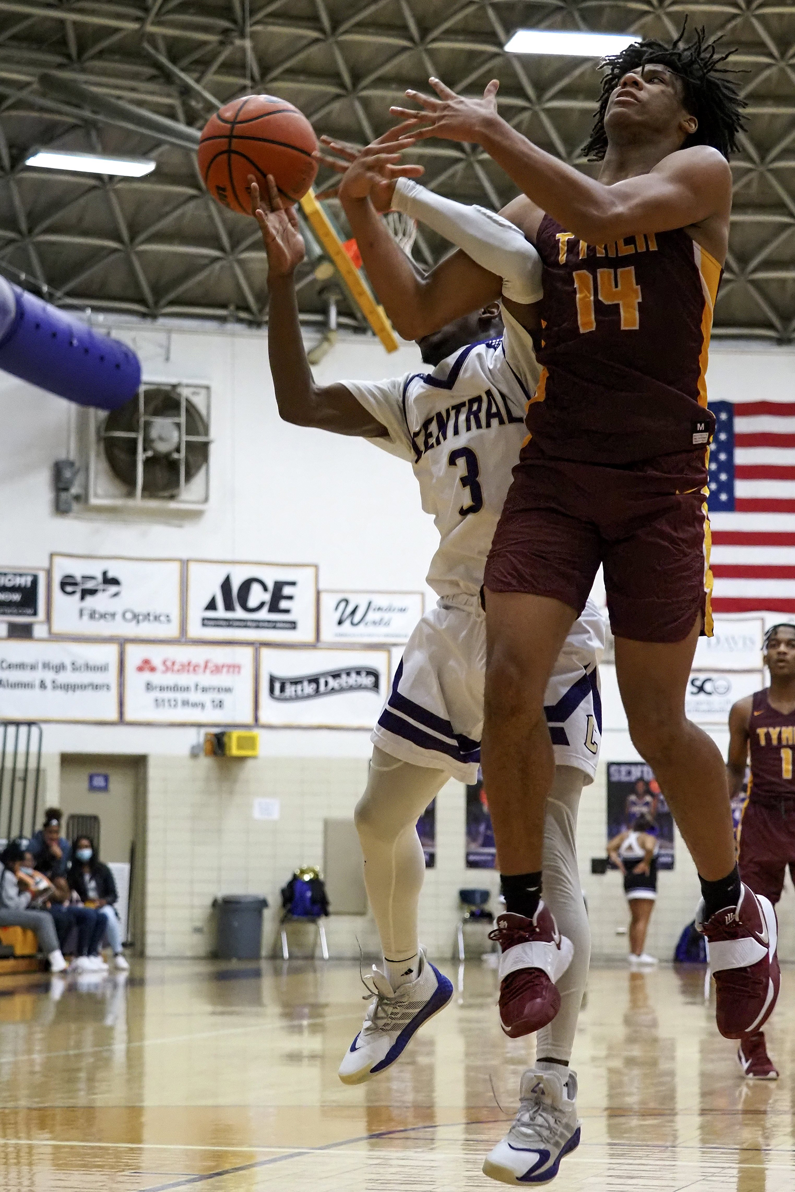 Staff photo by C.B. Schmelter / Tyner's Latavious Conyers (14) and Central's Kenneth Steward (3) go for the ball at Central High School on Friday, Feb. 12, 2021 in Chattanooga, Tenn.
