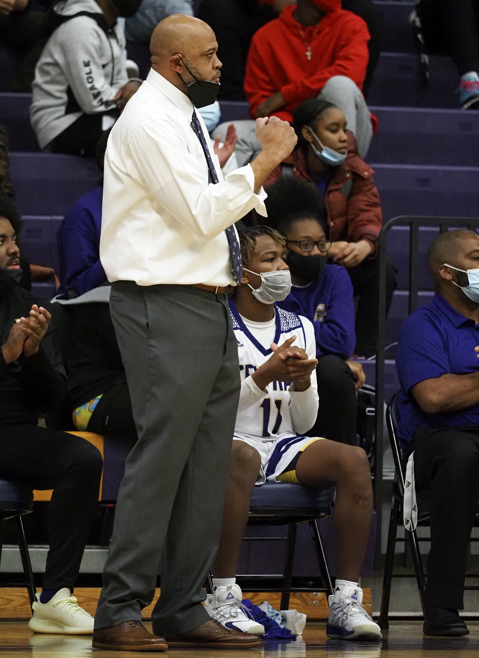 Staff photo by C.B. Schmelter / Central head coach Kantonio Davis fist pumps during a game against Tyner at Central High School on Friday, Feb. 12, 2021 in Chattanooga, Tenn.
