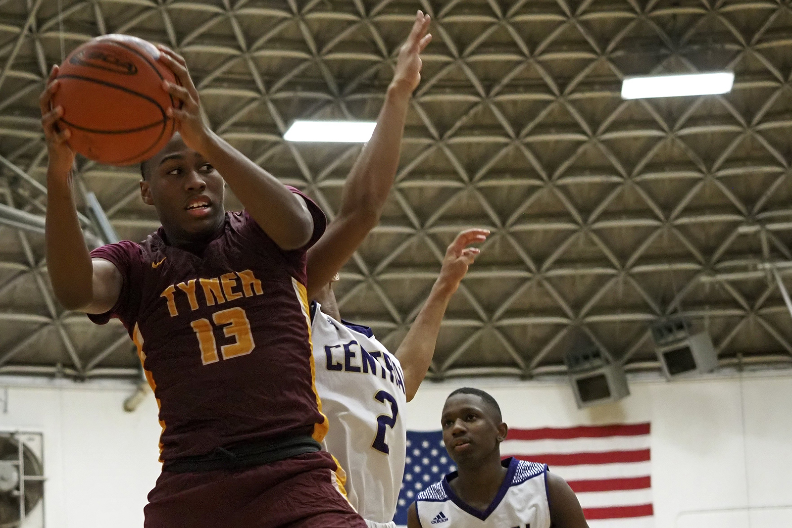 Staff photo by C.B. Schmelter / Tyner's Keelan Jackson (13) comes down with the ball against Donovin Taylor-Wade (2) and Central at Central High School on Friday, Feb. 12, 2021 in Chattanooga, Tenn.