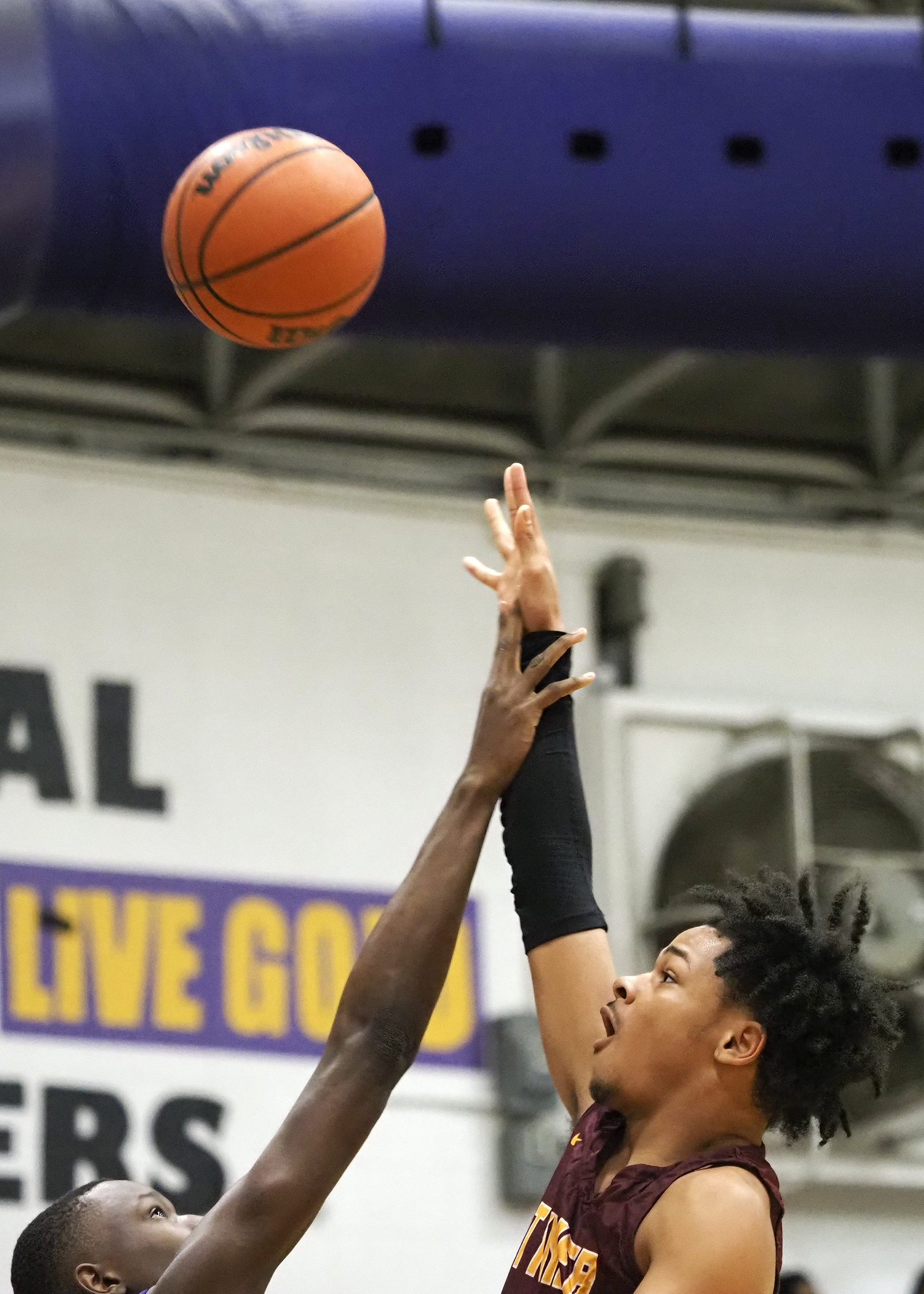 Staff photo by C.B. Schmelter / Tyner's Amarion Dillard (3) takes a shot over Central's D.J. Standerfer (13) at Central High School on Friday, Feb. 12, 2021 in Chattanooga, Tenn.