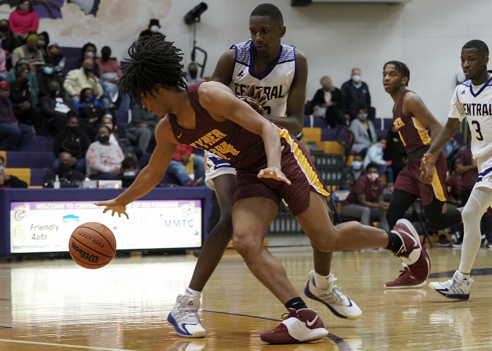 Staff photo by C.B. Schmelter / Tyner's Latavious Conyers (14) loses his handle on the ball against Central's D.J. Standerfer (13) at Central High School on Friday, Feb. 12, 2021 in Chattanooga, Tenn.