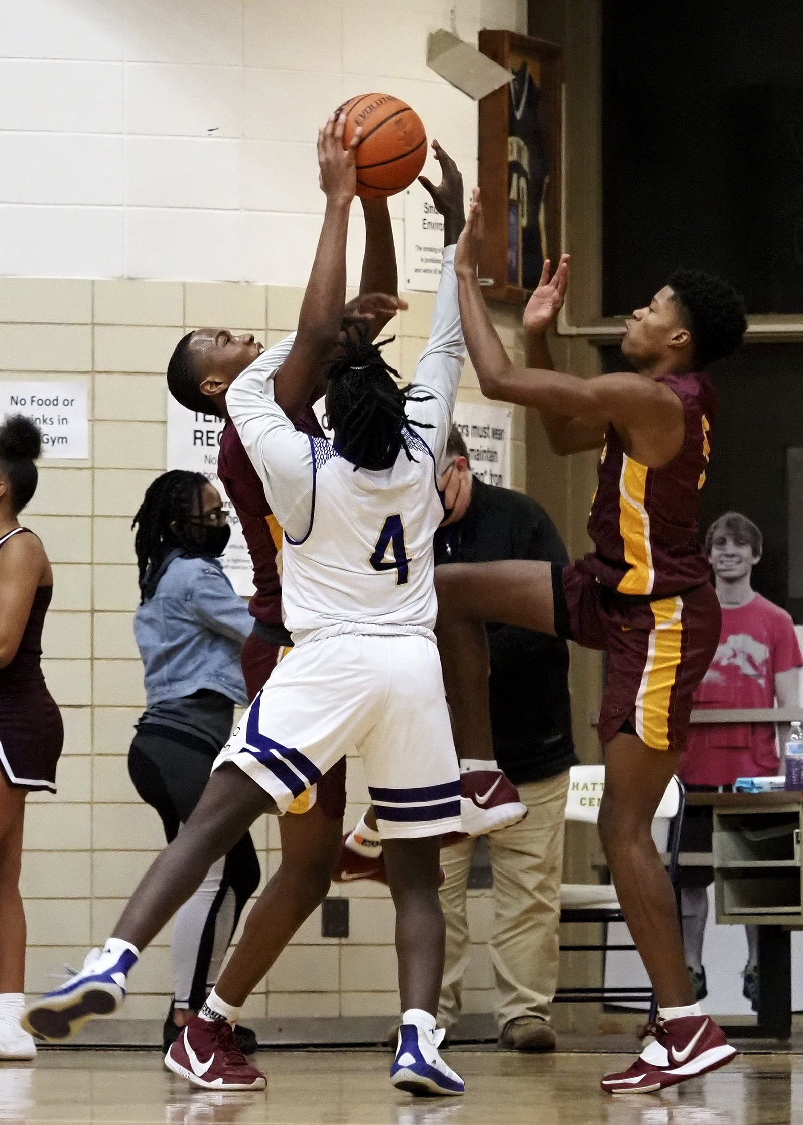 Staff photo by C.B. Schmelter / Tyner's Keelan Jackson (13) and Javontay Ross (5) fight Central's Garnett Howard (4) for the ball at Central High School on Friday, Feb. 12, 2021 in Chattanooga, Tenn.