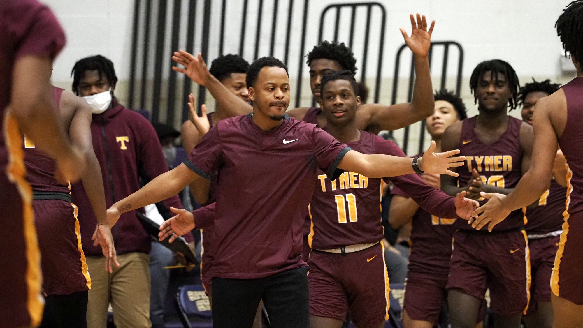Staff photo by C.B. Schmelter / Tyner head coach E.J. Ward greets his teammates after a quick start against Central at Central High School on Friday, Feb. 12, 2021 in Chattanooga, Tenn.