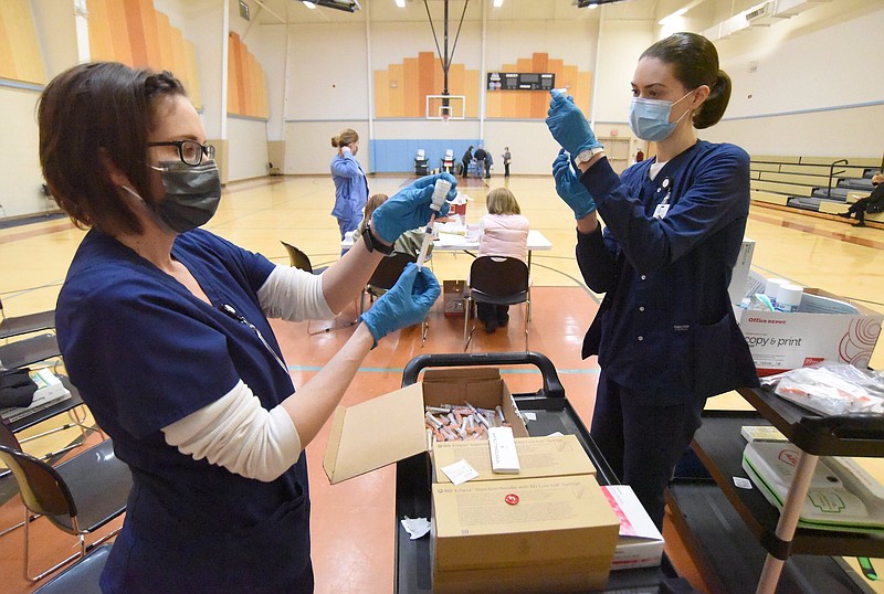 Staff Photo by Matt Hamilton / Dalton State College nursing students Jennifer Swinford, left, and Mary Peden fill syringes with COVID-19 vaccine at the Murray County Rec Department in Chatsworth on Monday, Feb. 8, 2021.