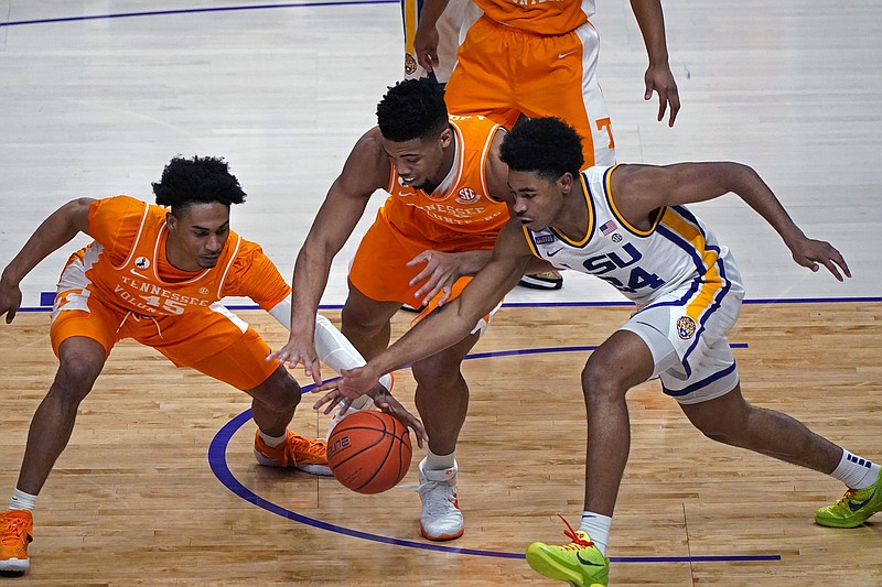 AP photo by Gerald Herbert / LSU guard Cameron Thomas, right, battles for a loose ball with Tennessee guard Keon Johnson, left, and forward E.J. Anosike in the first half of an SEC matchup Saturday afternoon in Baton Rouge, La.