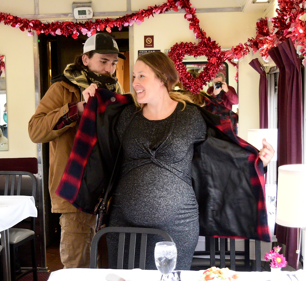 Staff Photo by Robin Rudd / Samuel Bolton helps his wife Roxanne Bolton with her coat, as the Chickamauga Georgia Couple take their seats in the Traveler's Fair Dining Car.