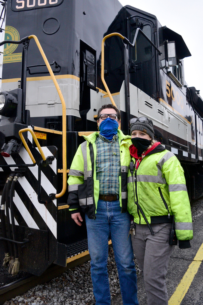 Staff Photo by Robin Rudd / Engineer Andrew Durden, left, is engaged to his conductor Rikki Burckett, right.