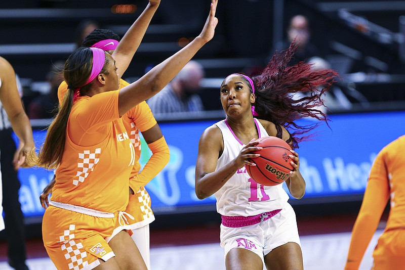 College Station Eagle photo by Cassie Stricker via AP / Texas A&M's Kayla Wells (11) eyes the basket during an SEC game against Tennessee on Sunday in College Station, Texas.