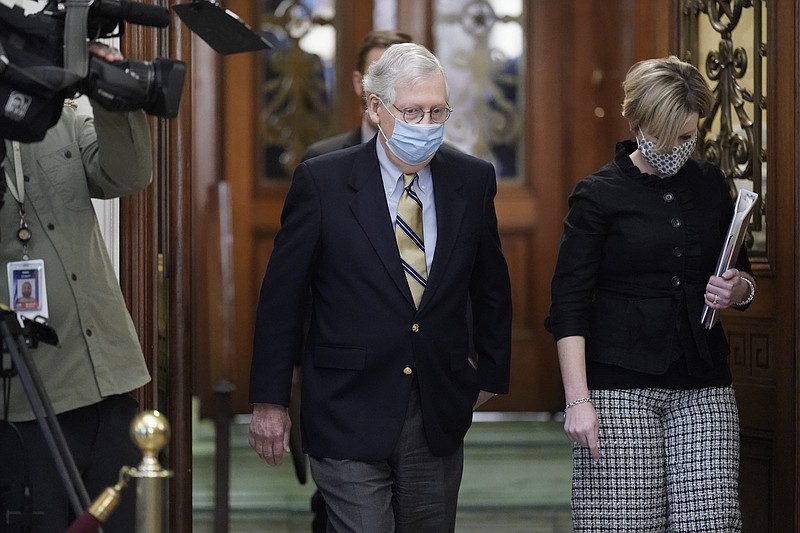 Photo by J. Scott Applewhite of The Associated Press / Senate Minority Leader Mitch McConnell of Kentucky walks in the Capitol as the Senate convenes in a rare weekend session for final arguments in the second impeachment trial of former President Donald Trump at the Capitol in Washington on Saturday, Feb. 13, 2021.