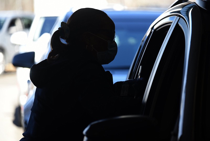 Staff Photo by Matt Hamilton / Nurse Darlene Toney prepares to administer a dose of the COVID-19 vaccine at the vaccination site at the Tennessee Riverpark on Tuesday, Jan. 26, 2021. Some Hamilton County teachers are driving to nearby counties to receive the vaccine.