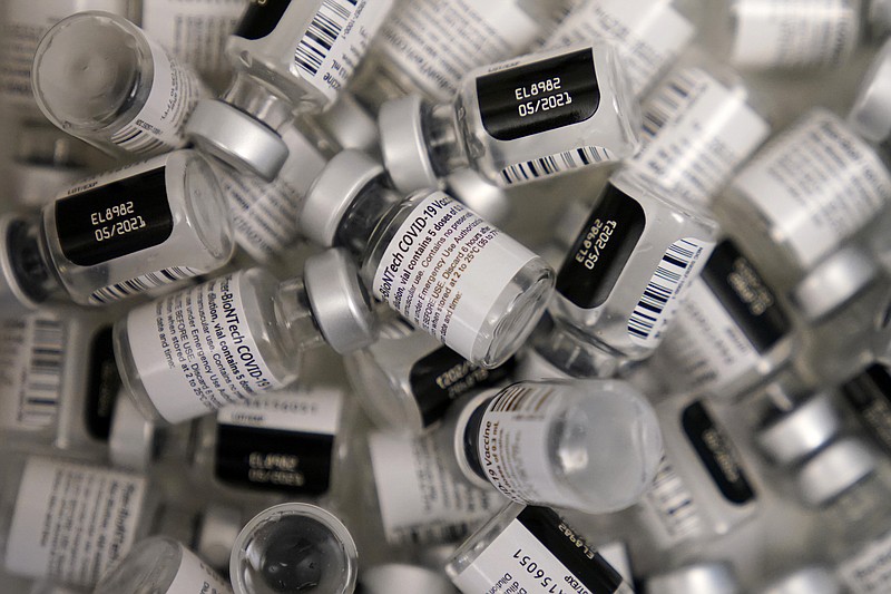 In this Jan. 22, 2021, file photo, empty vials of the Pfizer-BioNTech COVID-19 vaccine are seen at a vaccination center at the University of Nevada, Las Vegas, in Las Vegas. The makers of COVID-19 vaccines are figuring out how to tweak their recipes against worrisome virus mutations — if and when the shots need an update. (AP Photo/John Locher, File)