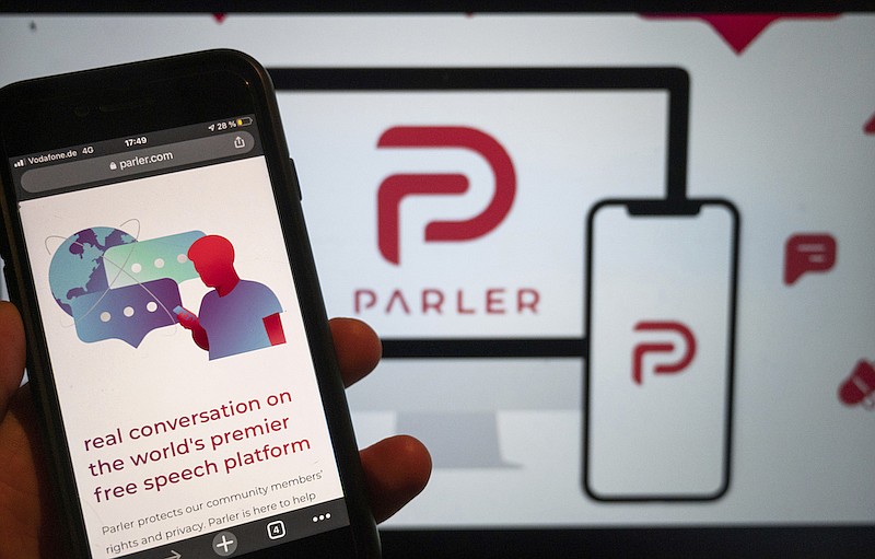 In this Jan. 10, 2021, file photo, the website of the social media platform Parler is displayed in Berlin. The right-wing friendly social network Parler, which was forced offline following the Jan. 6 attack on the U.S. Capitol by supporters of then-President Donald Trump, said it is re-launching, Monday, Feb. 15, 2021. (Christophe Gateau/dpa via AP, File)