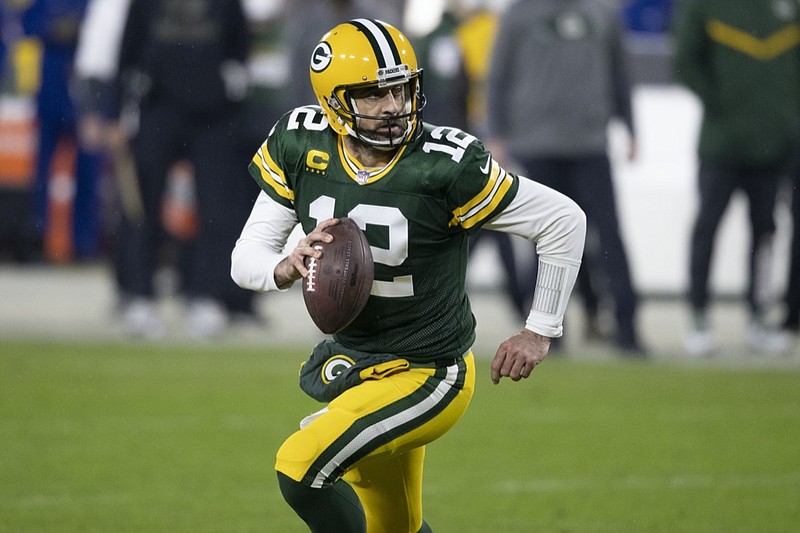 FILE - In this Jan. 16, 2021, file photo, Green Bay Packers quarterback Aaron Rodgers (12) runs with the ball during the team's NFL divisional playoff football game against the Los Angeles Rams in Green Bay, Wis. Rodgers earned his third Associated Press Most Valuable Player award, Saturday, Feb. 6, at the NFL Honors. (AP Photo/Jeffrey Phelps, File)