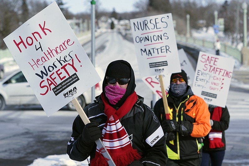 Nurses picket Friday, Feb. 12, 2021 in Faribault, Minn., during a healthcare worker protest of a shortage on protective masks. One year into the COVID-19 pandemic, the U.S.  finds itself with many millions of N95 masks pouring out of American factories and heading into storage. Yet there still aren't nearly enough in ICU rooms and hospitals. (AP Photo/Jim Mone)