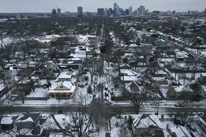 Snow and ice grips a neighborhood in East Austin on Tuesday, Feb. 16, 2021. Day six of the statewide freeze and still millions of Texans are without power. (Bronte Wittpenn /Austin American-Statesman via AP)